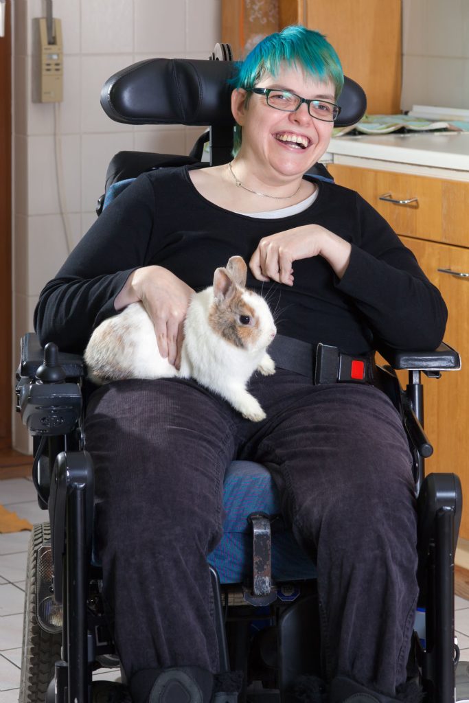 woman in wheelchair with pet bunny