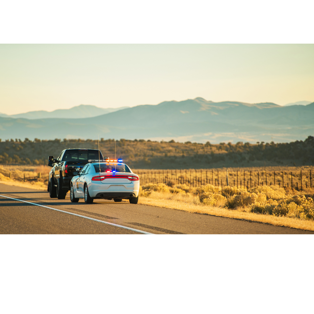 Image of a truck being pulled over by a police vehicle.